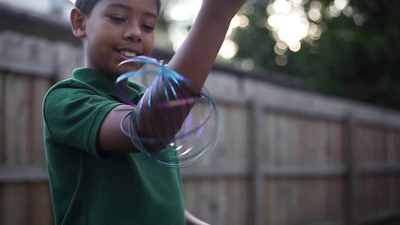 A boy spinning a Mozi flow bracelet between his hands